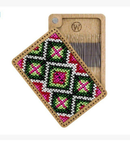 a wooden comb with a needle on it