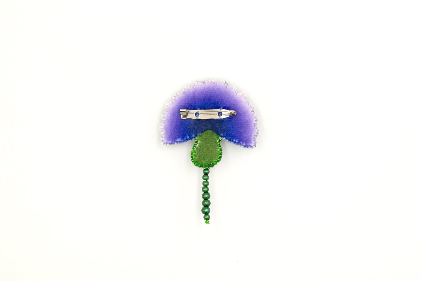 a purple flower with a green stem on a white background