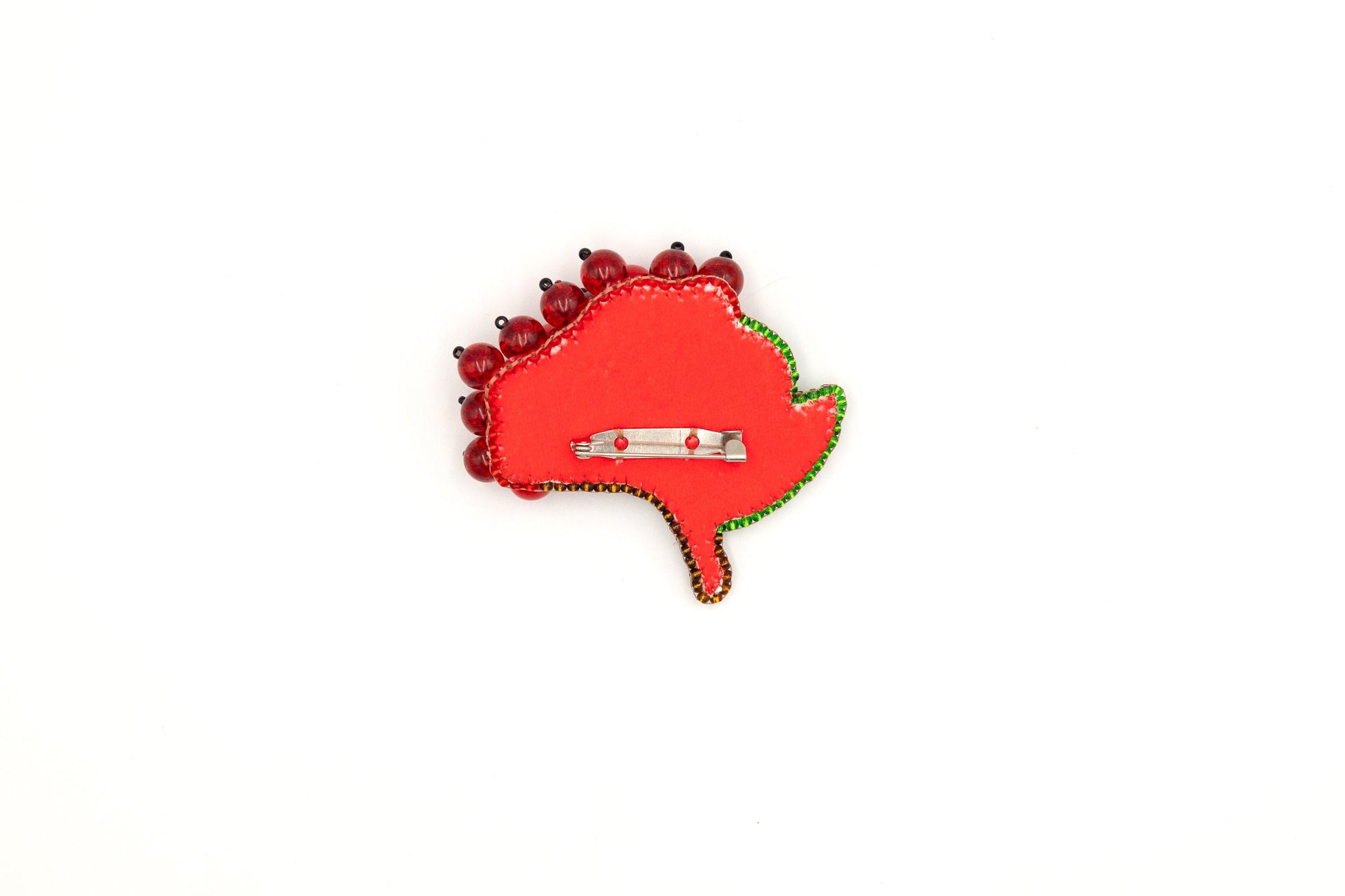 a red brooch with a car on it