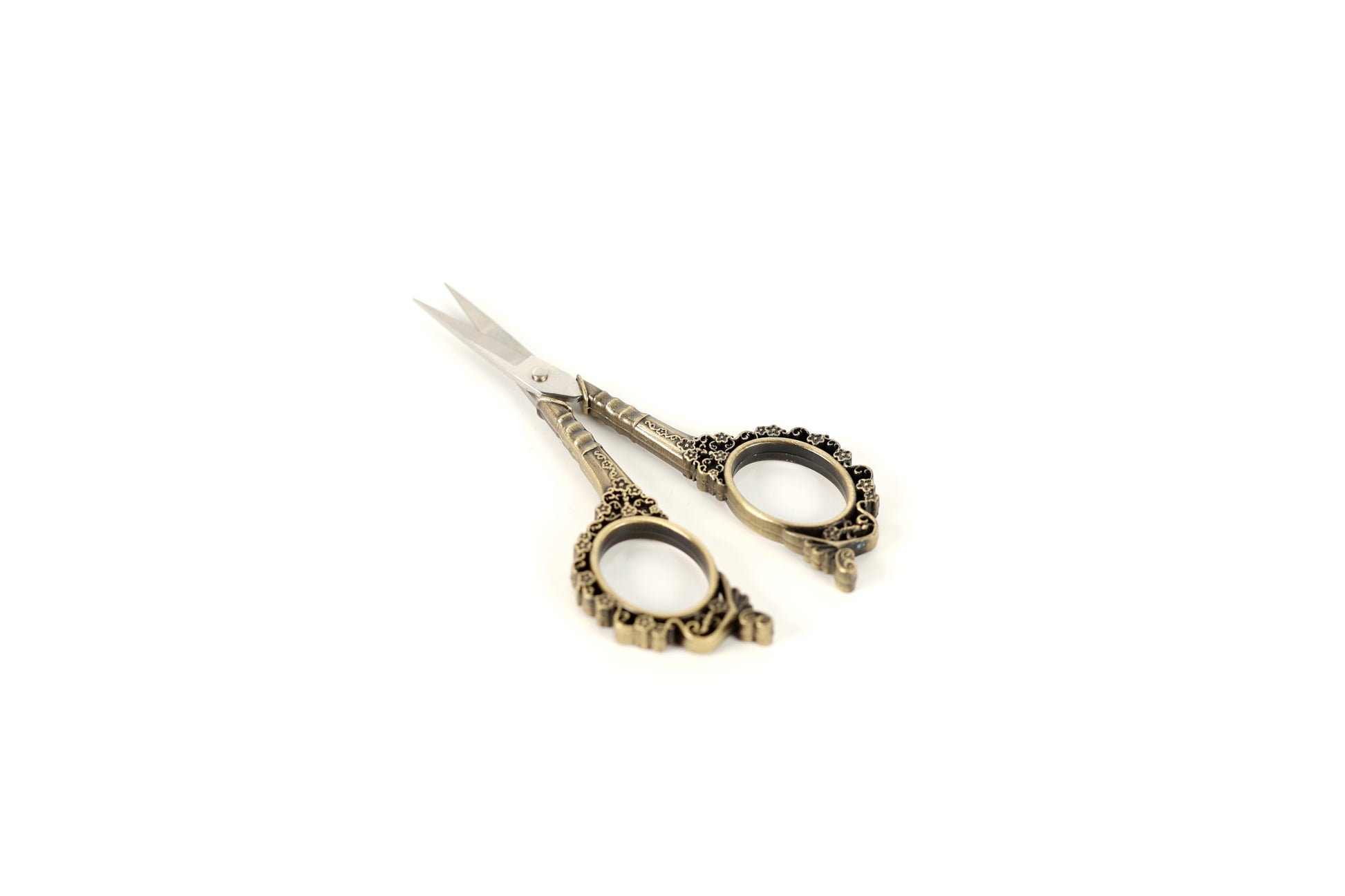 A pair of ornate scissors with decorative handles is shown against a white background.