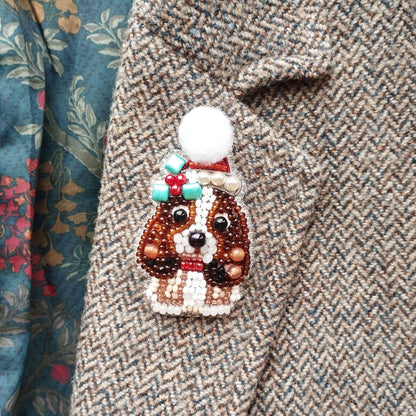 A close-up of a beaded dog brooch on a tweed jacket.