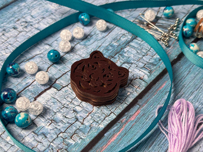 a close up of a piece of jewelry on a table