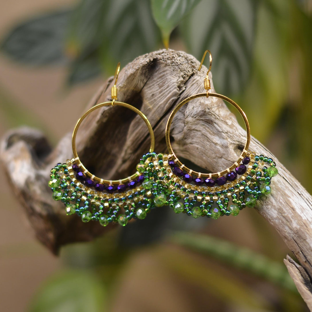 a close up of a pair of earrings on a branch