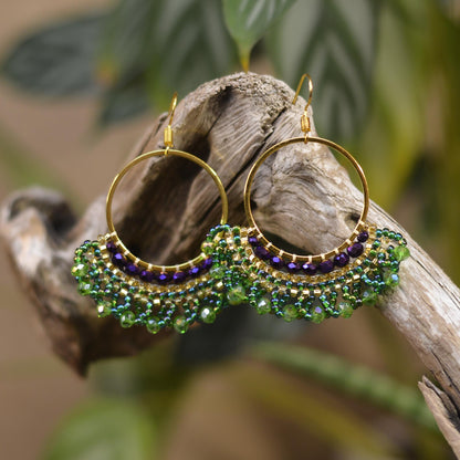 a close up of a pair of earrings on a branch
