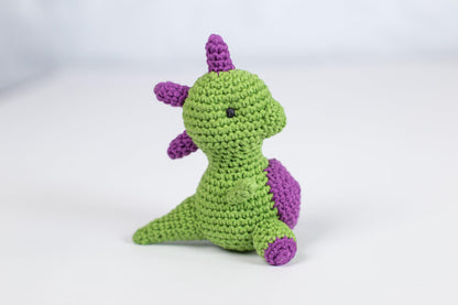 a crocheted green and purple stuffed animal