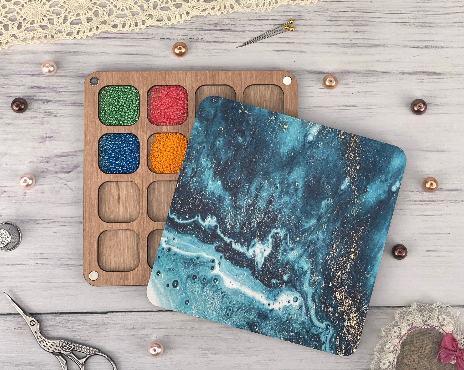 a wooden board with a painting and a pair of scissors next to it