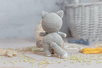 a crocheted teddy bear sitting on top of a table