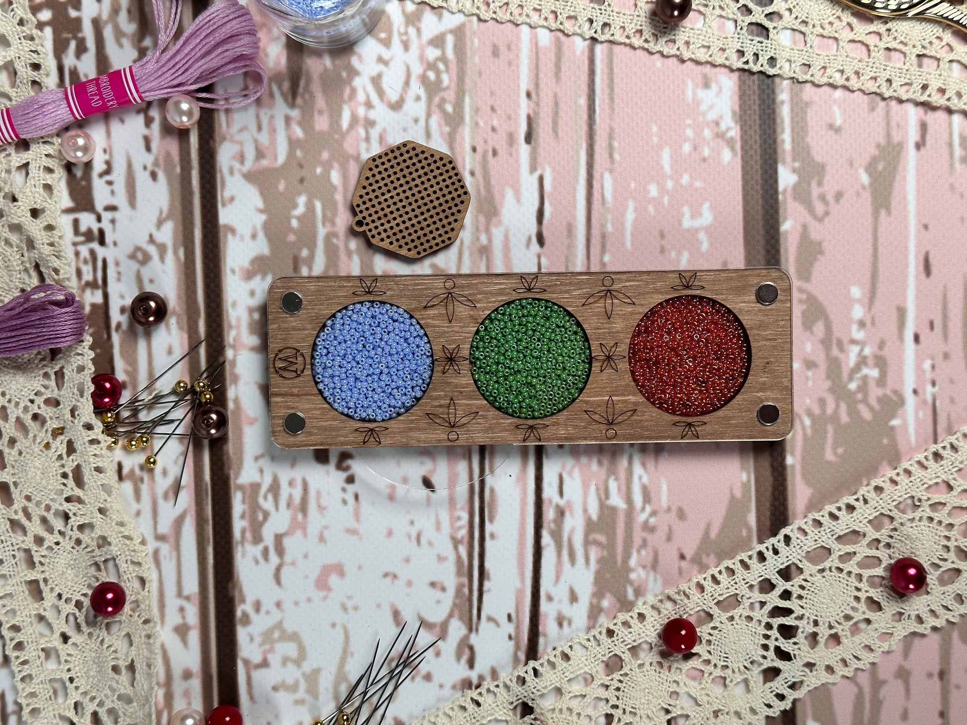 a piece of wood with some beads on it