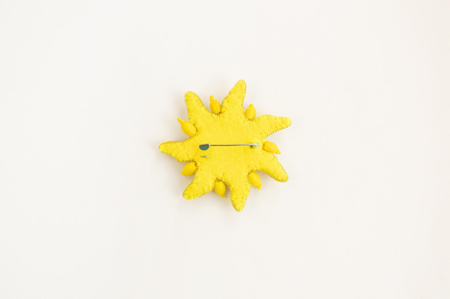 a yellow clock with a yellow face on a white surface