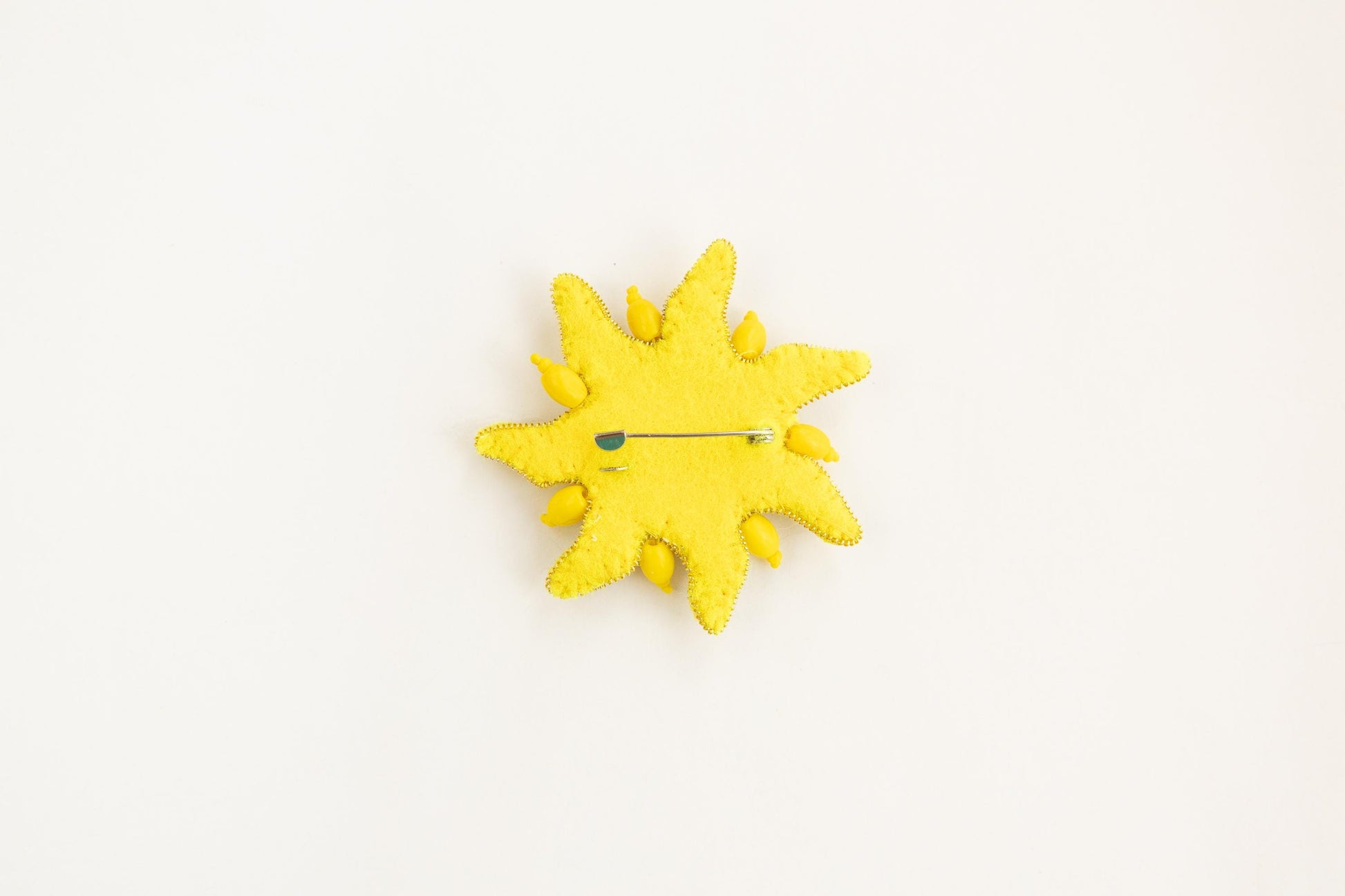 a yellow clock with a yellow face on a white surface