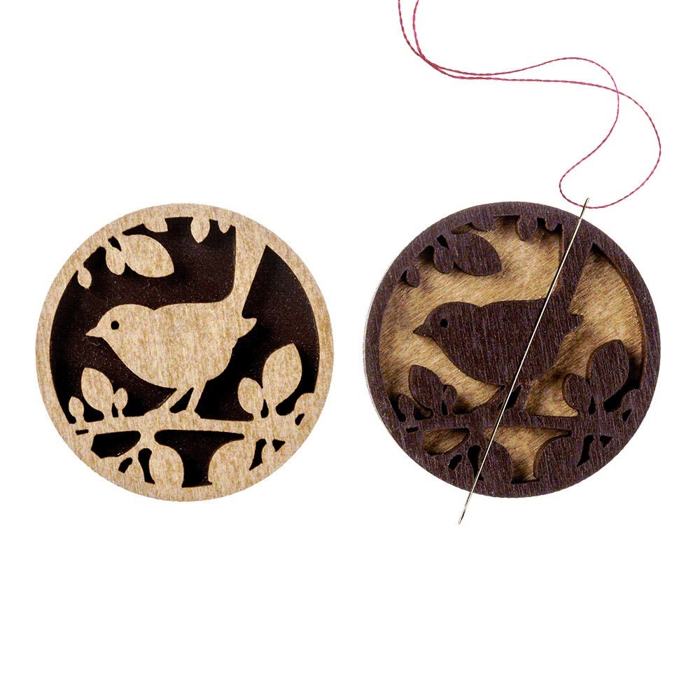 a pair of wooden buttons with birds on them