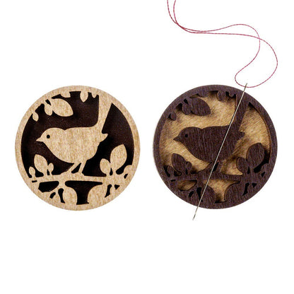 a pair of wooden buttons with birds on them