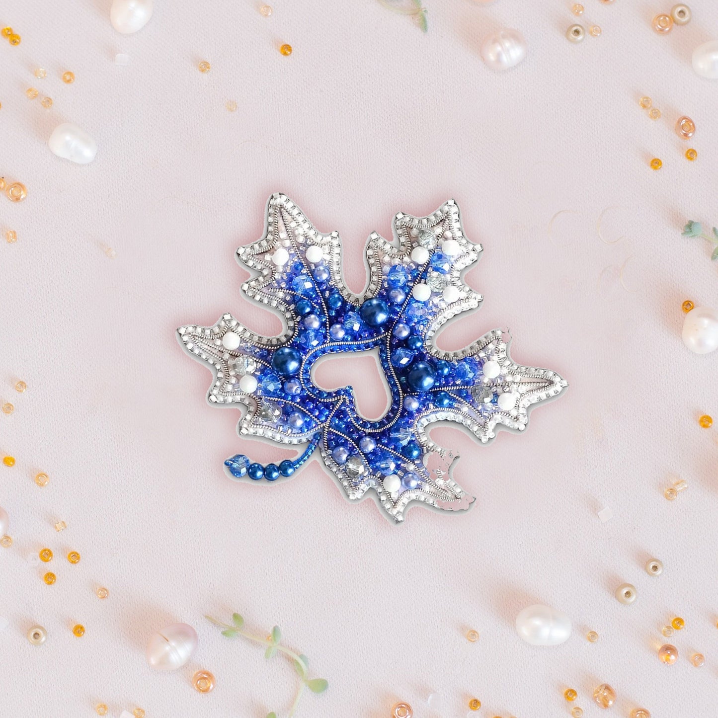 a blue and white brooch sitting on top of a table