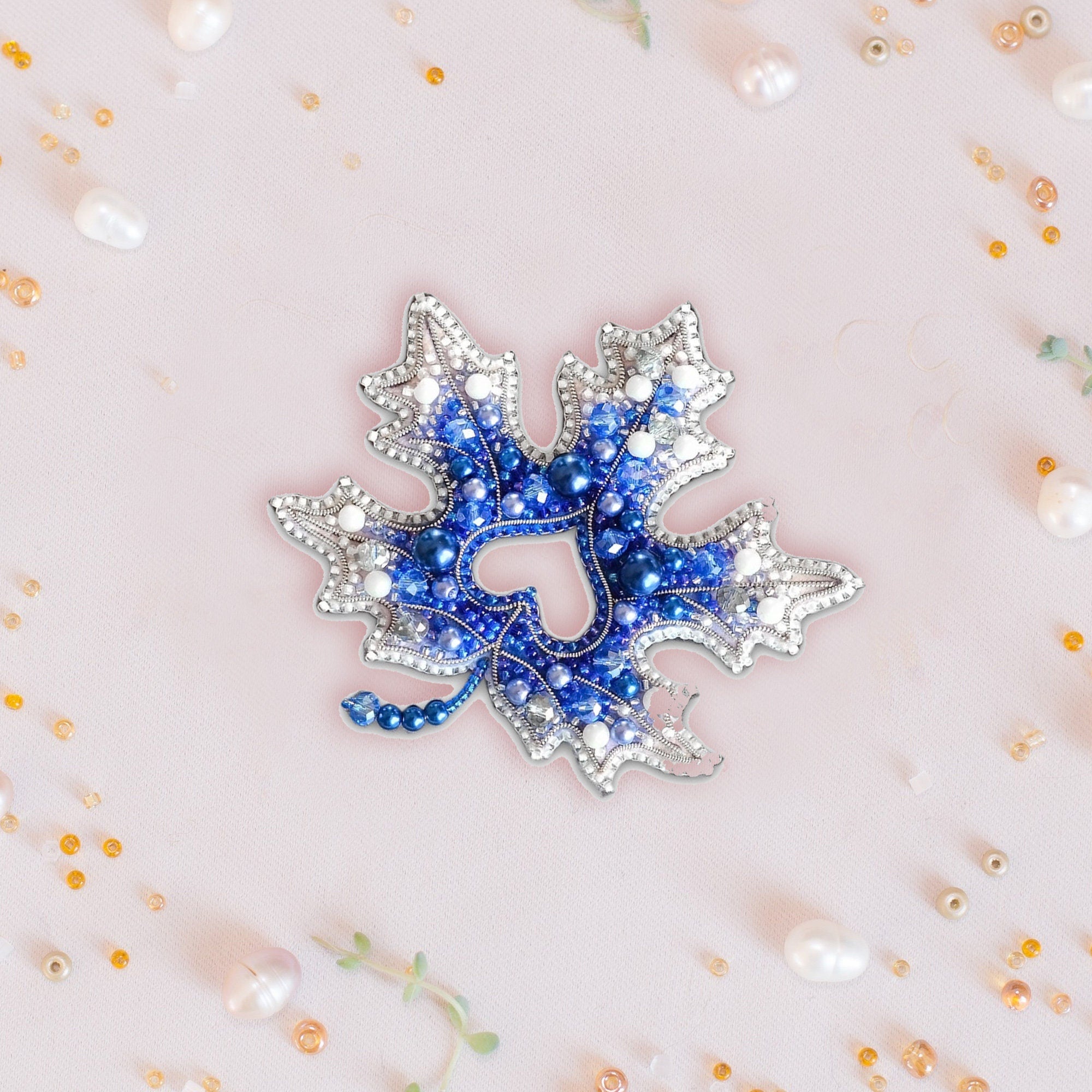 a blue and white brooch sitting on top of a table