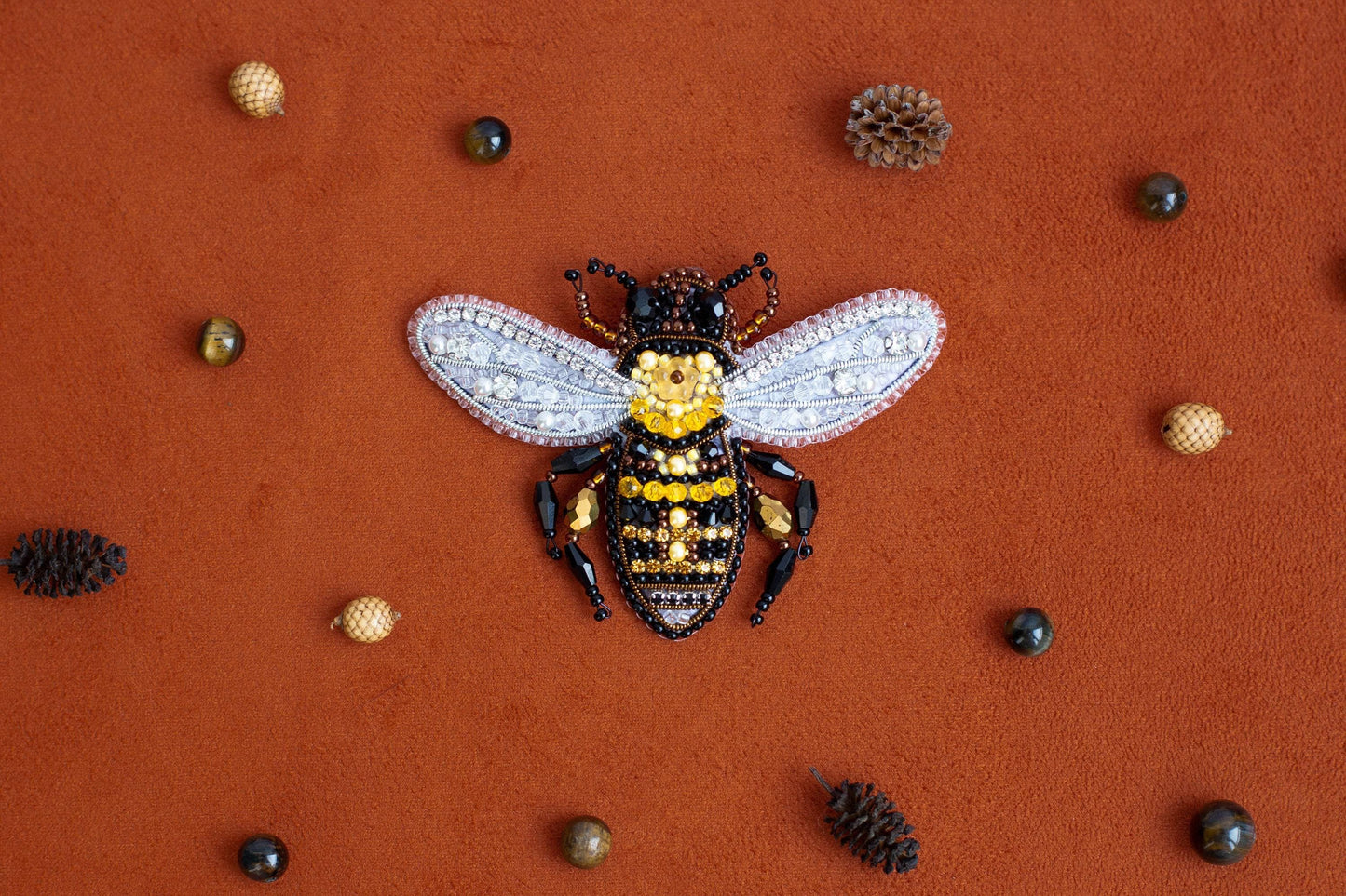 a yellow and black bee sitting on top of a red surface
