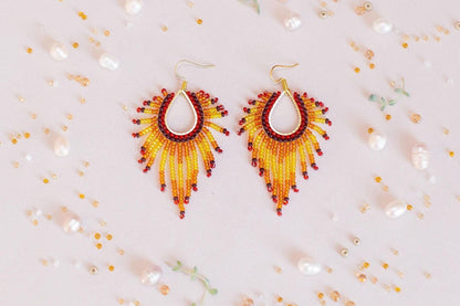 a pair of yellow and red beaded earrings