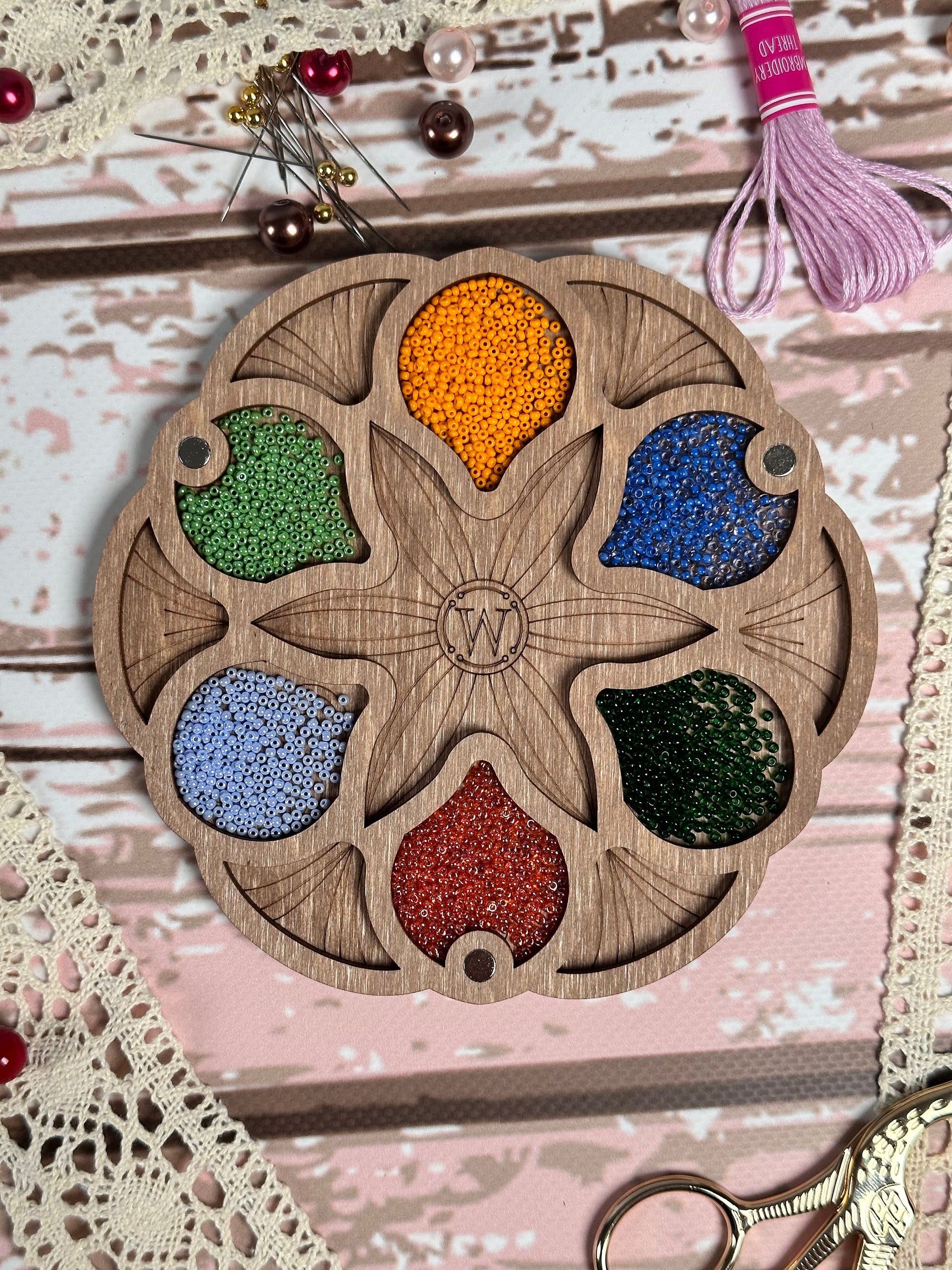 a picture of a wooden plate with a bunch of beads on it