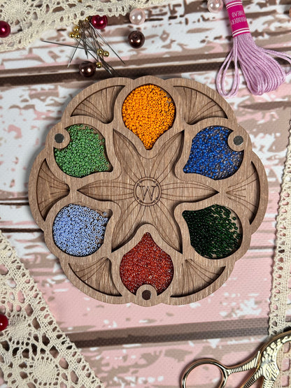 a picture of a wooden plate with a bunch of beads on it