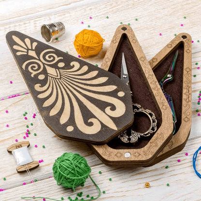 a pair of scissors and a pair of scissors in a wooden box