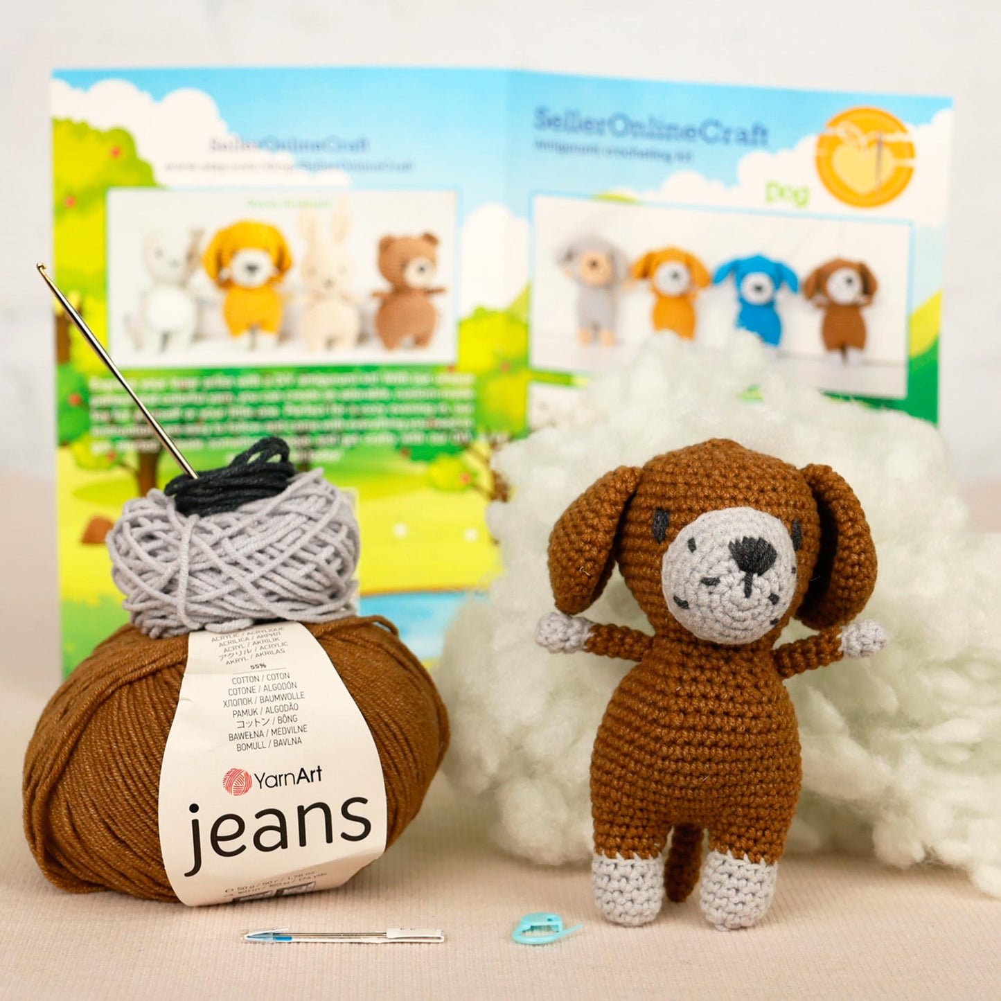 a crocheted dog next to a ball of yarn