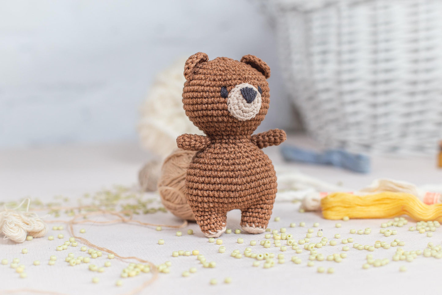 a crocheted teddy bear sitting on top of a table