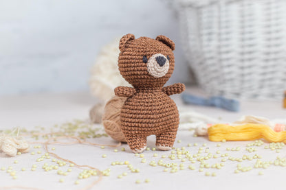 a crocheted teddy bear sitting on top of a table