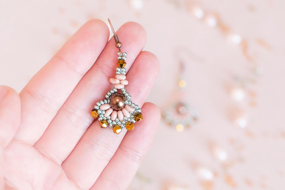 a pair of blue and black beaded earrings