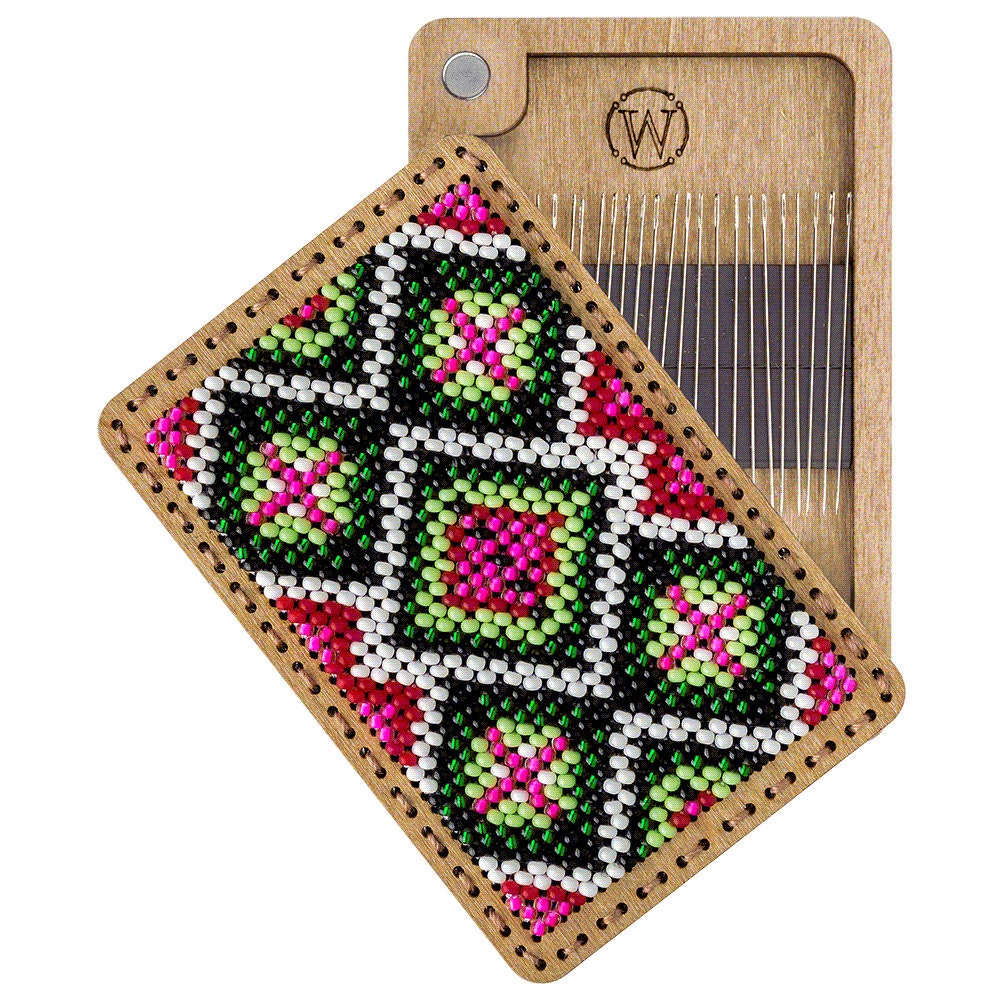a piece of wood with a beaded design on it