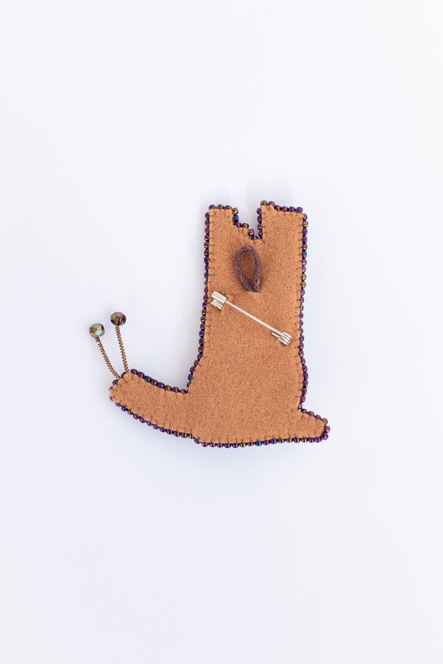 a brooch with a pin in the shape of a boot