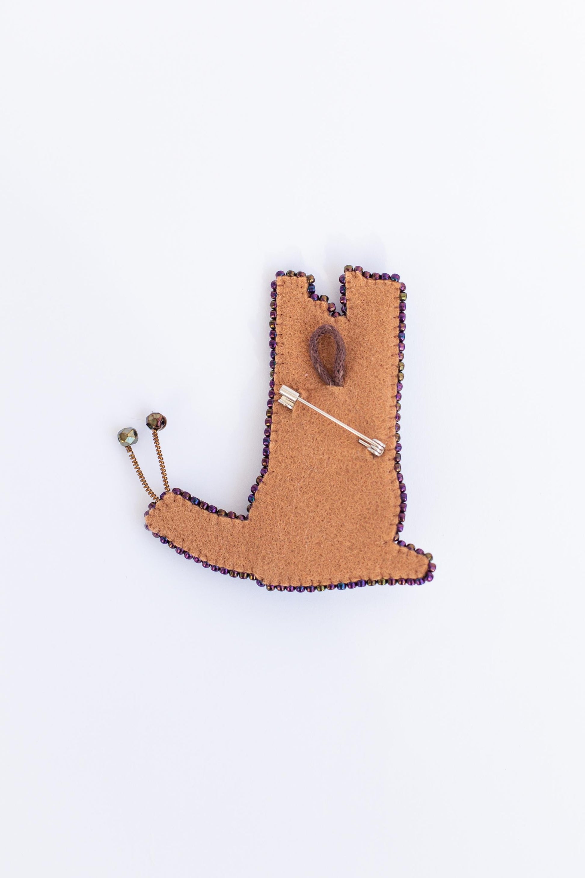 a brooch with a pin in the shape of a boot