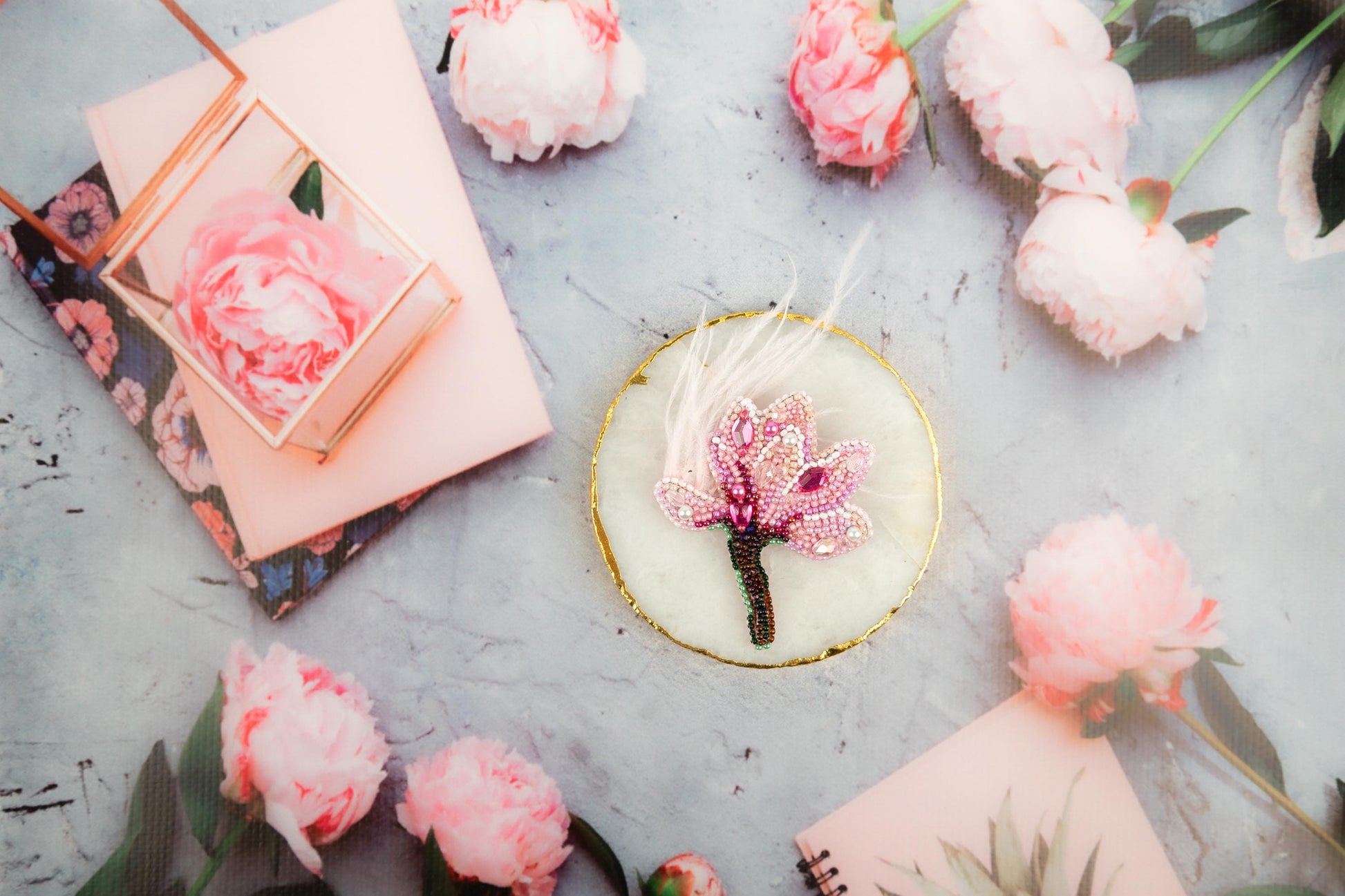 a small pink flower sitting on top of a table