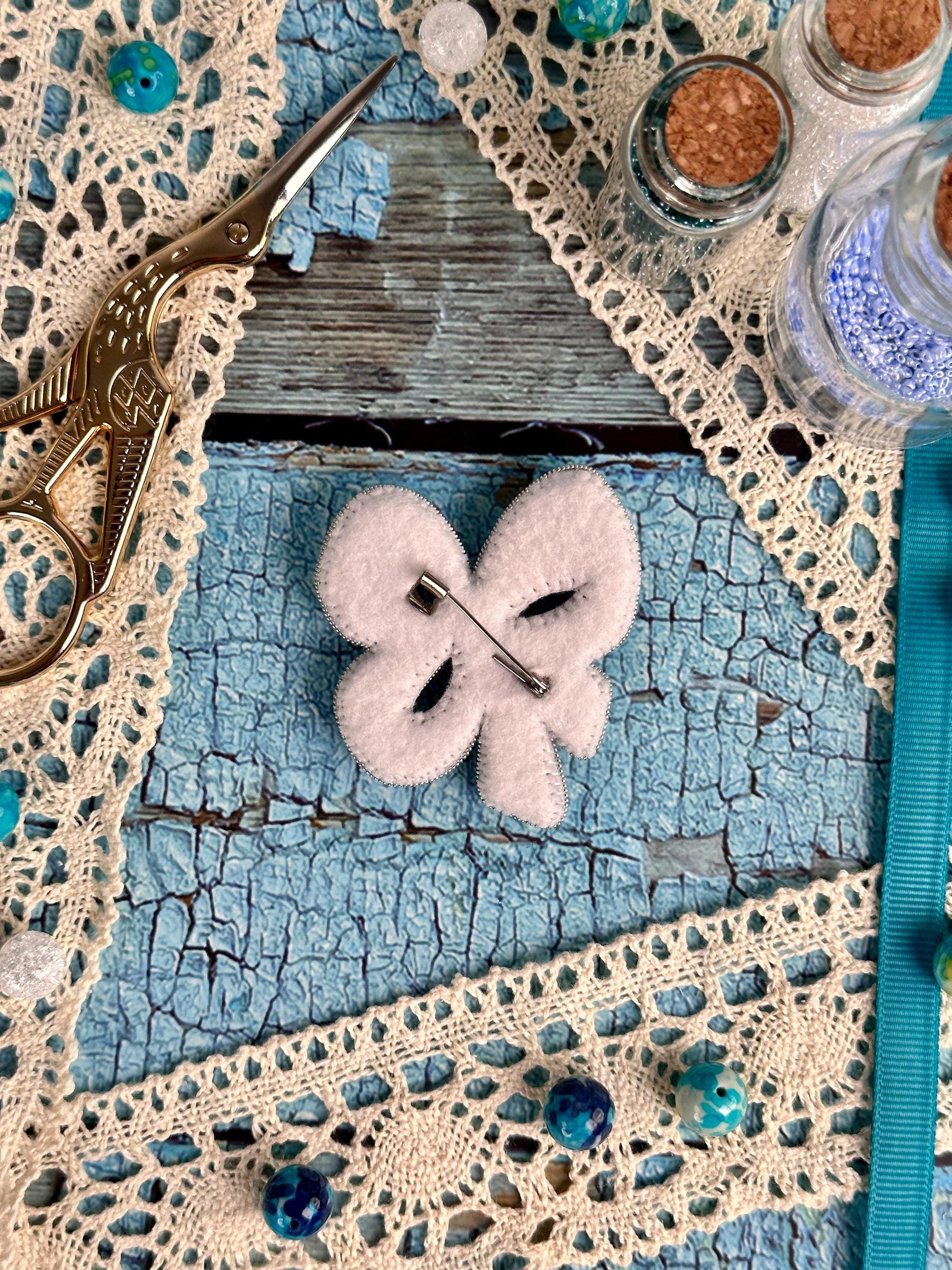a pair of scissors sitting on top of a piece of cloth