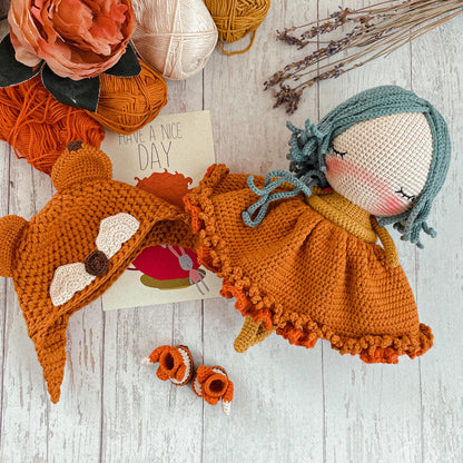 a group of knitted dolls sitting on top of a wooden floor