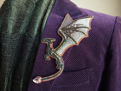 A purple jacket with a decorative dragon pin or brooch on the lapel.