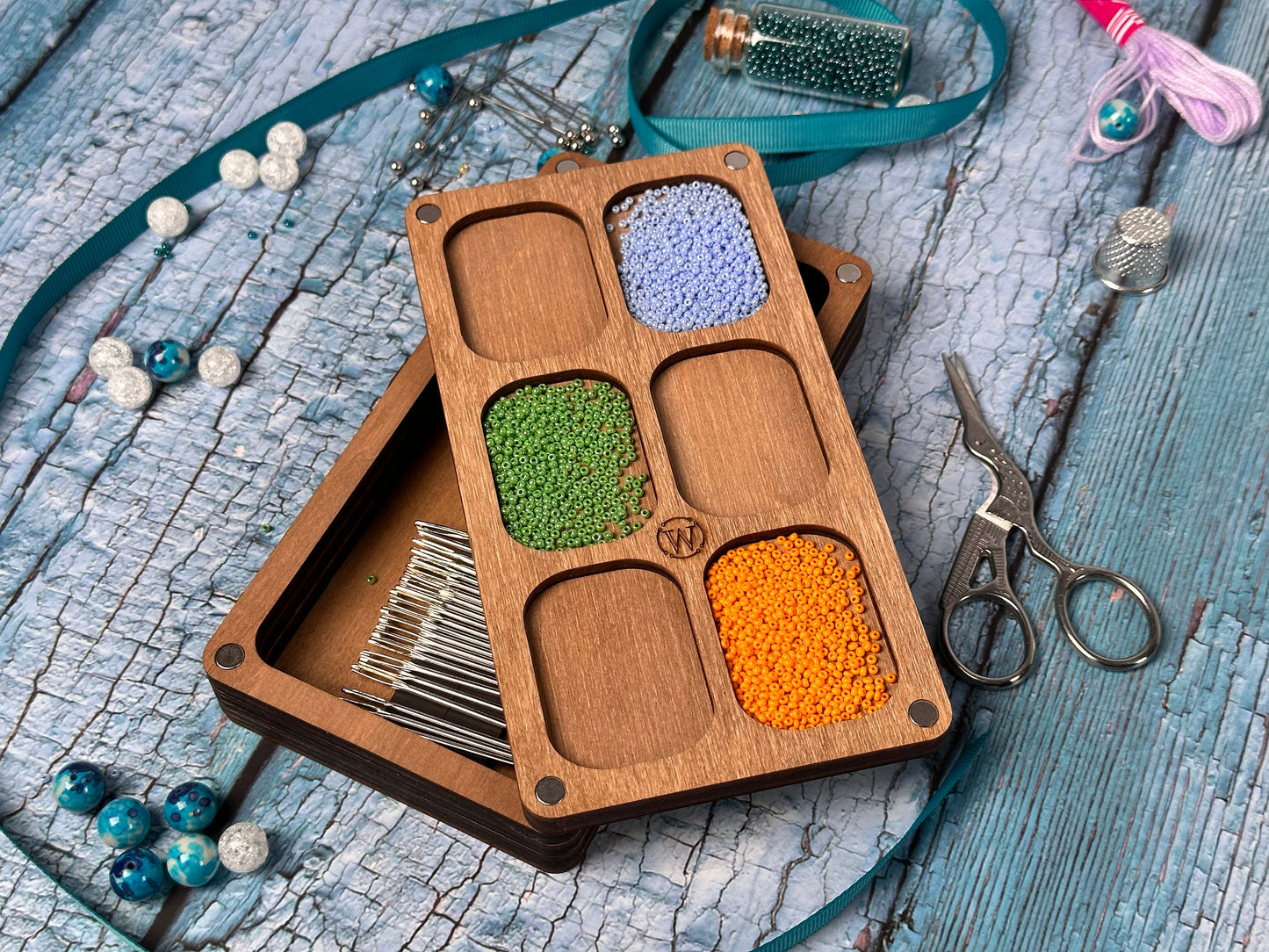 a wooden box filled with different colored beads