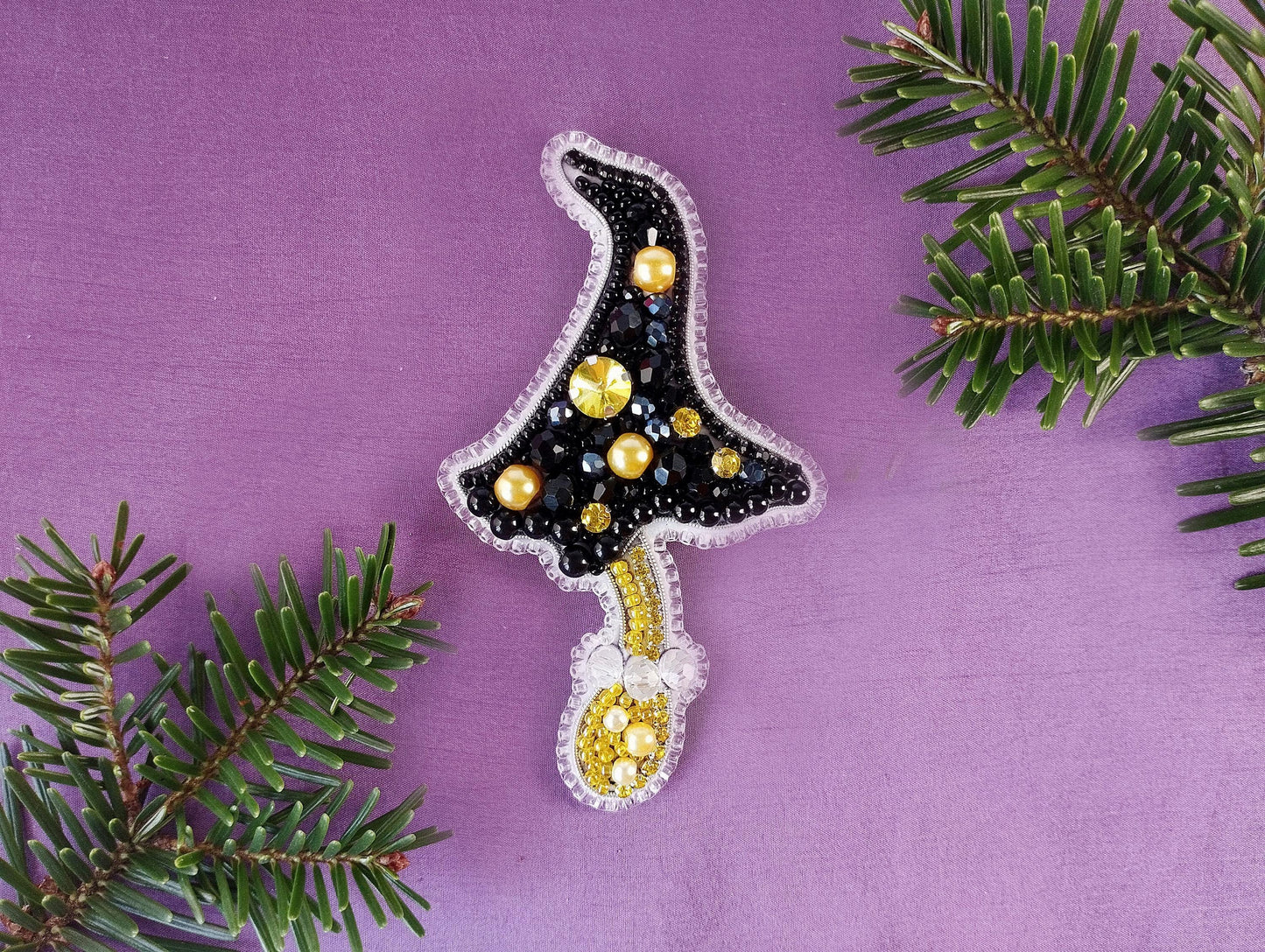 a christmas tree ornament hanging from a tree branch