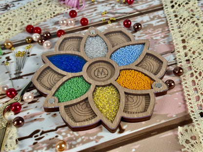 a decorative wooden object with beads and beads on a table