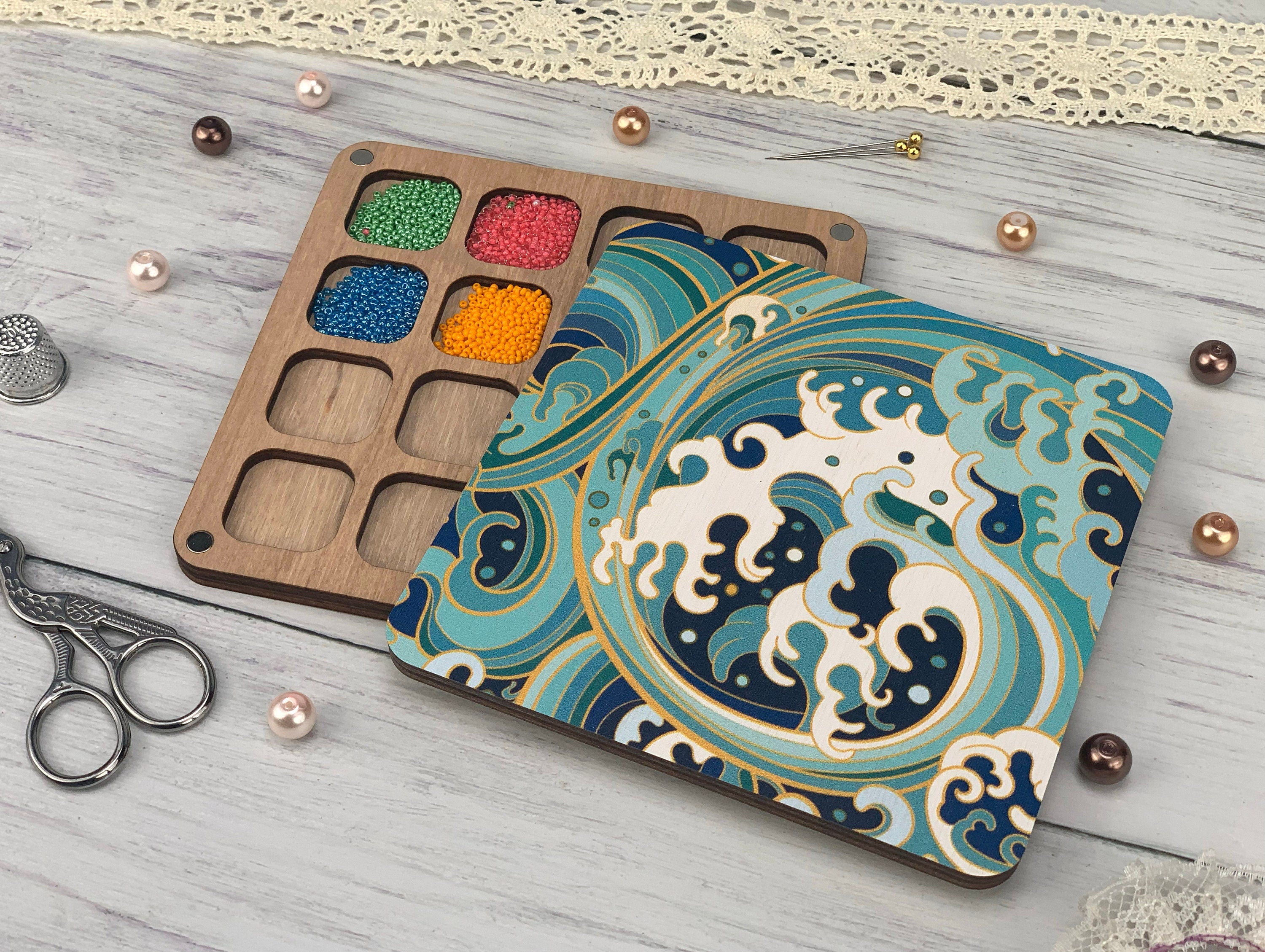 a wooden tray with some beads and a pair of scissors