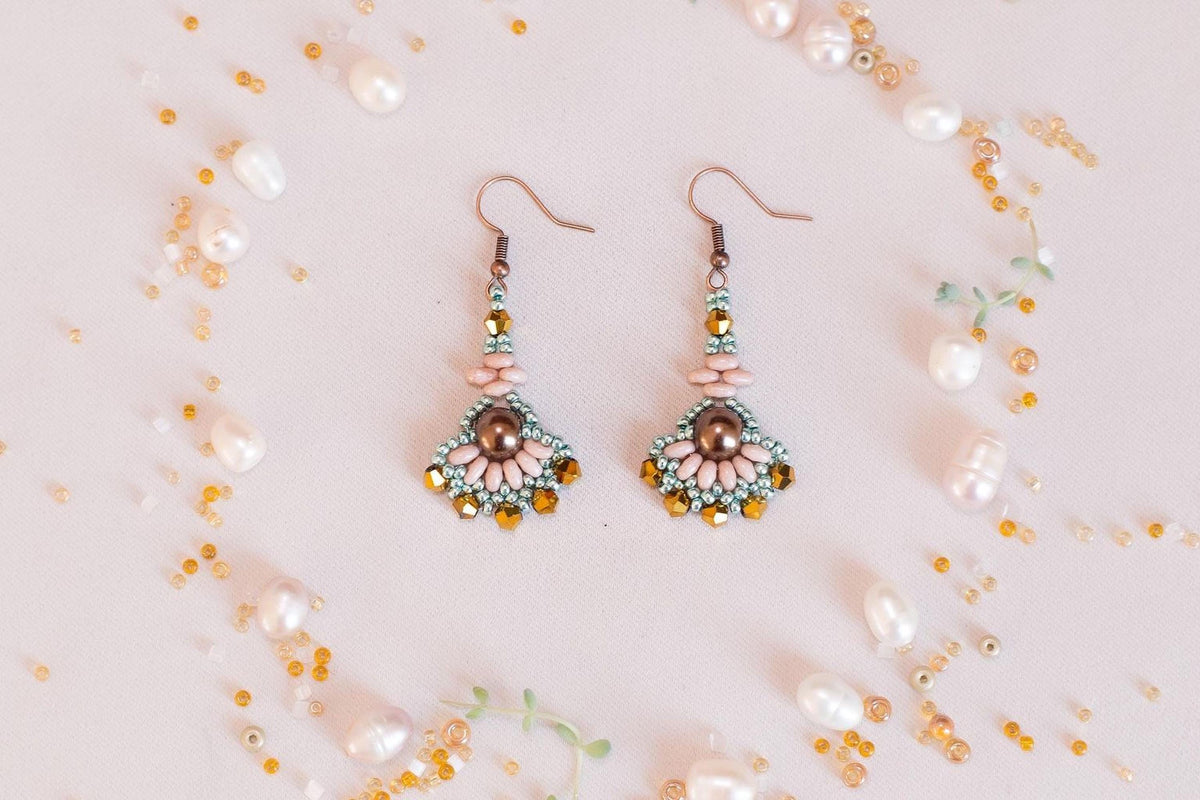 a pair of earrings sitting on top of a table