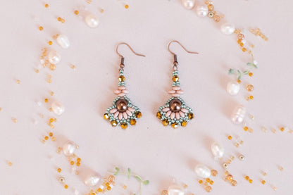 a pair of earrings sitting on top of a table