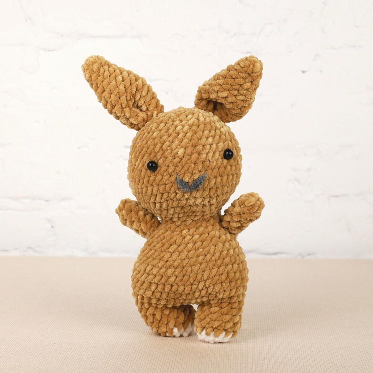 a small brown stuffed animal sitting on top of a table