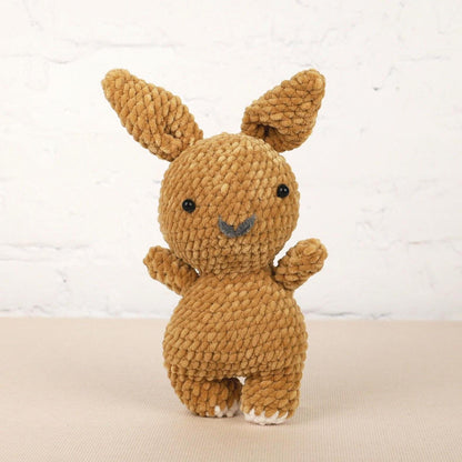a small brown stuffed animal sitting on top of a table