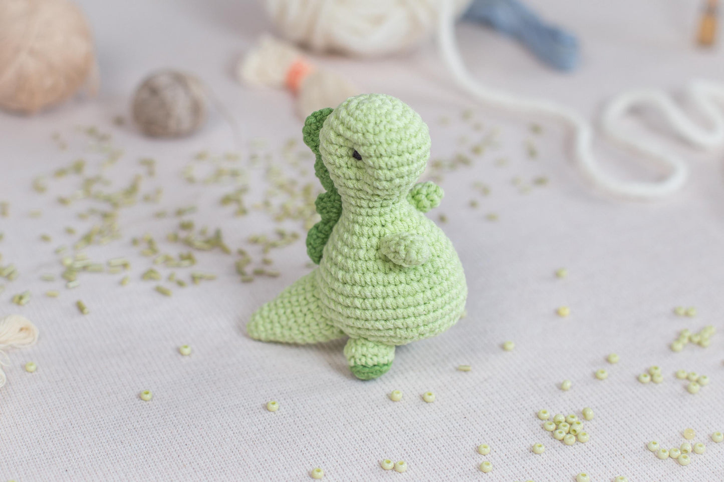 a green crocheted toy sitting on top of a table