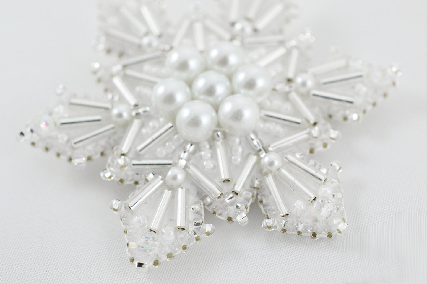 a snowflake made of pearls and crystal beads