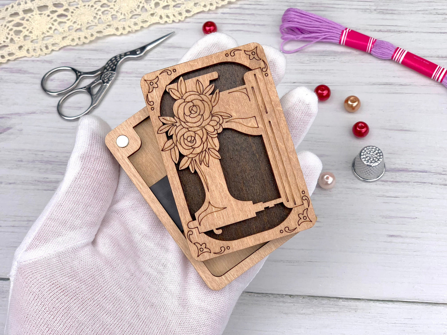 a hand holding a wooden cut out of a cross