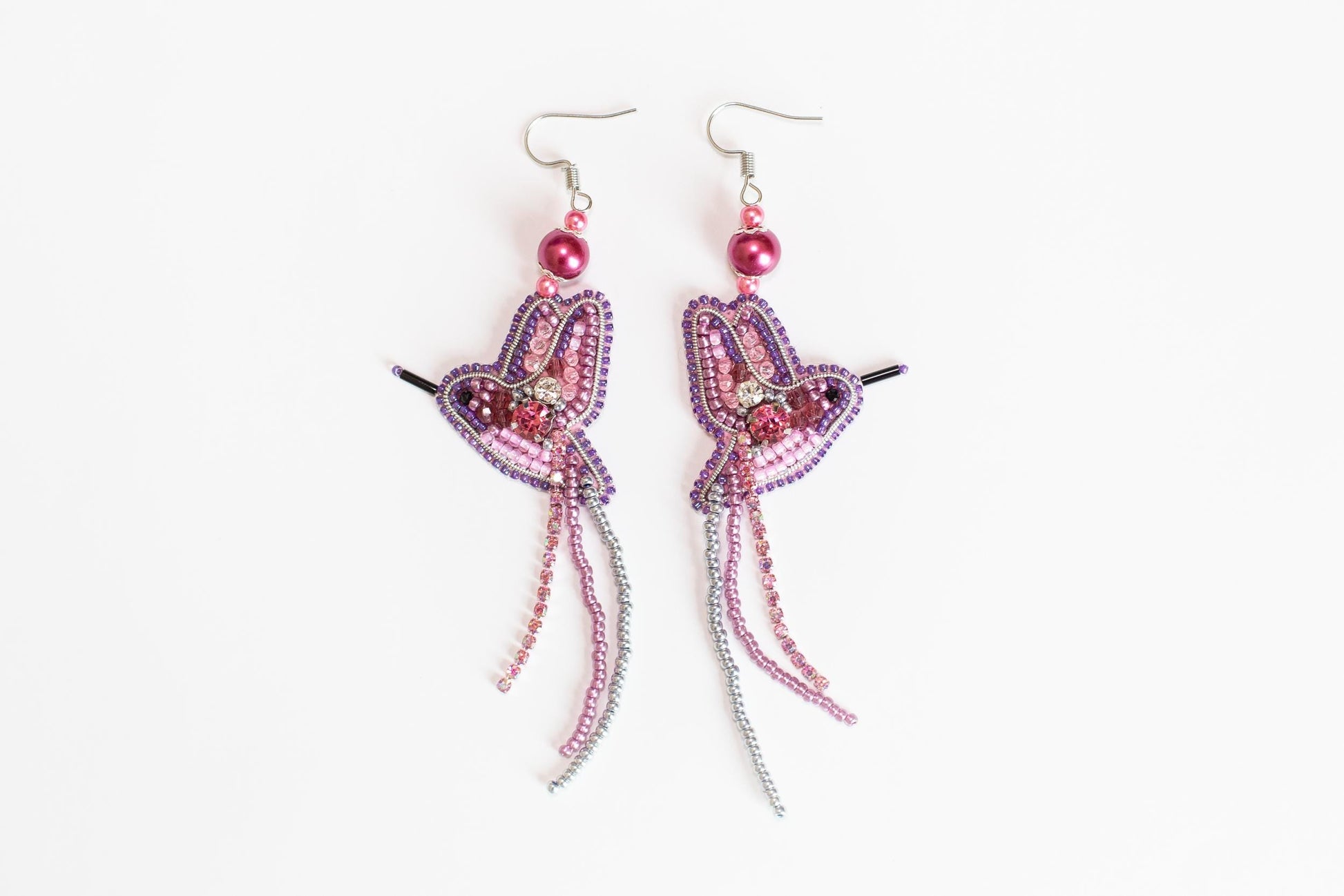 a pair of pink and purple beaded earrings