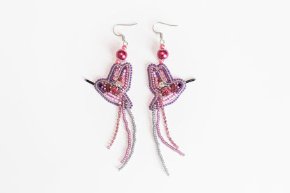 a pair of pink and purple beaded earrings
