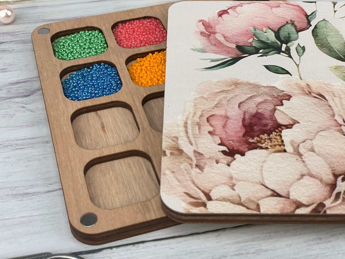 a wooden tray with a flower painted on it