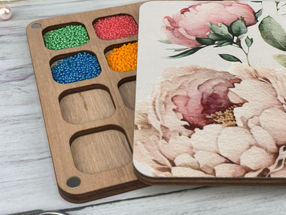 a wooden tray with a flower painted on it