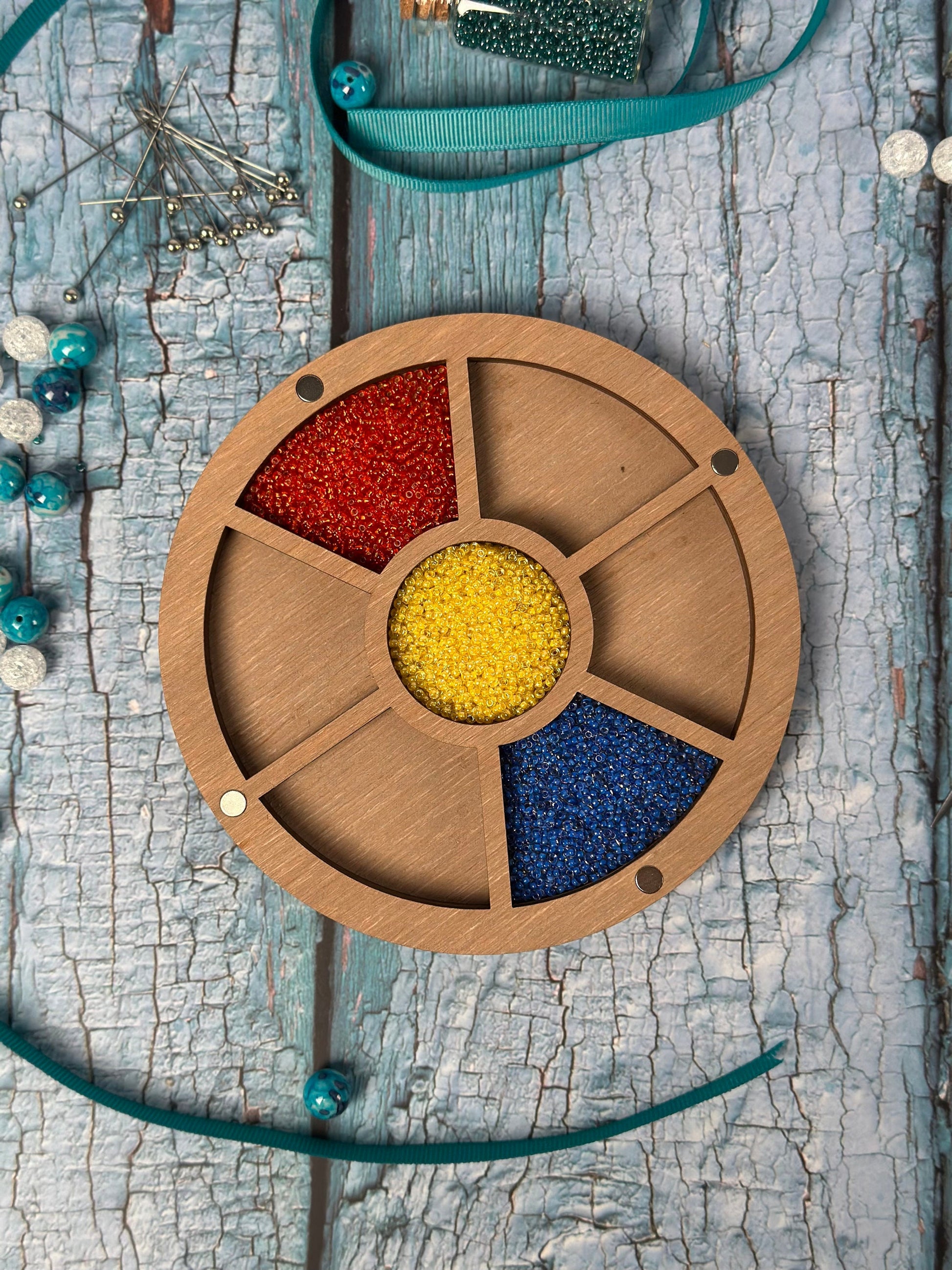 a wooden wheel with beads in it on a table